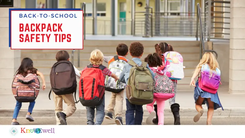 Elementary school kids running into school with large backpacks 