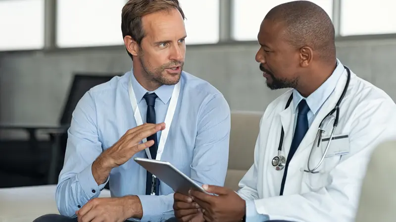 patient giving medical history to doctor