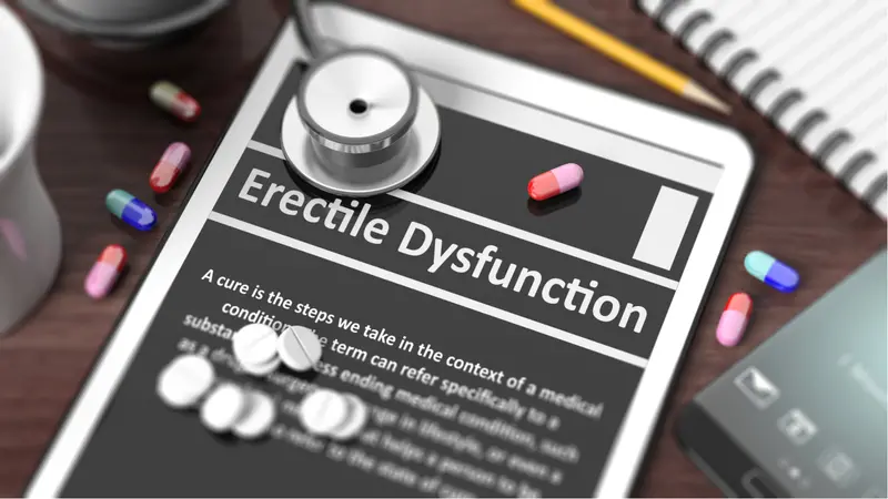 Tablet with "Erectile Dysfunction" on screen, stethoscope, and pills Tablet with "Erectile Dysfunction" on screen, stethoscope, and pills