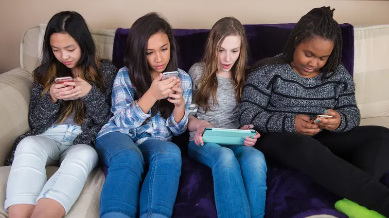 Group of kids on their mobile device Group of kids on their mobile device