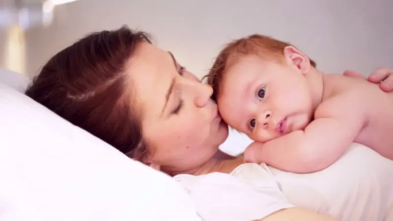 Mother and baby in bed