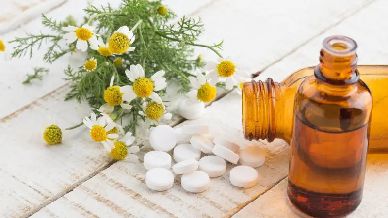 Homeopathy for Sleep and Stress, image of homeopathic treatment, essential oil bottle and flowers