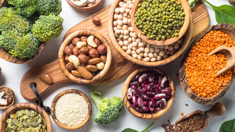 Vegan protein source. Beans, lentils, nuts, broccoli spinach and seeds. Top view on white table. Healthy vegetarian food. Vegan protein source. Beans, lentils, nuts, broccoli spinach and seeds. Top view on white table. Healthy vegetarian food.