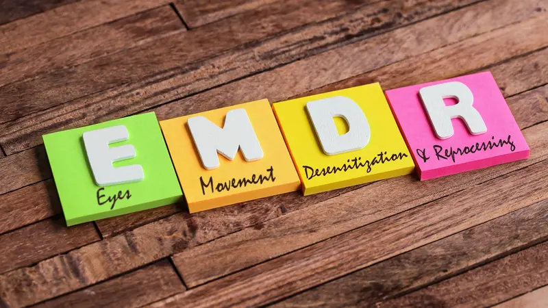 Colorful square papers with wooden white letters for the English acronym word, EMDR Colorful square papers with wooden white letters for the English acronym word, EMDR