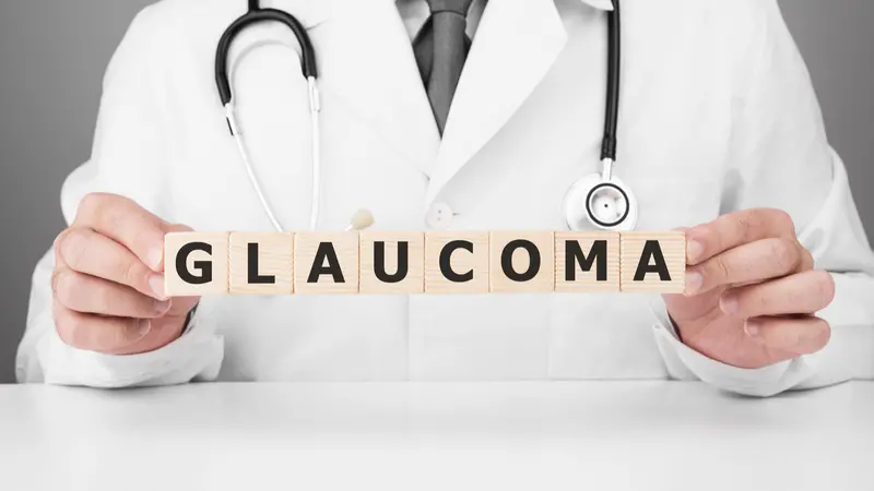 Doctor holds wooden cubes in his hands with text GLAUCOMA Doctor holds wooden cubes in his hands with text GLAUCOMA