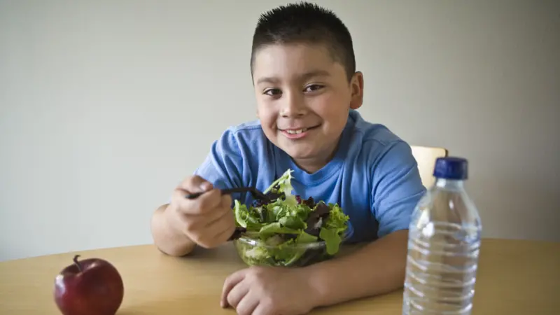 Portrait of a happy obese boy on a diet