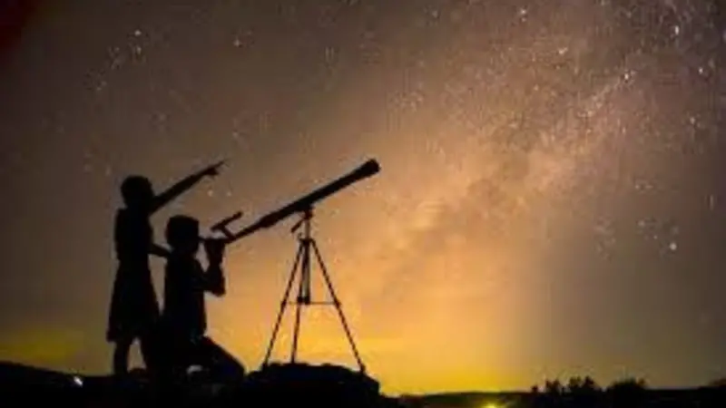 Family Stargazing party Silhouette of a parent and child looking into a telescope and pointing at the night sky.
