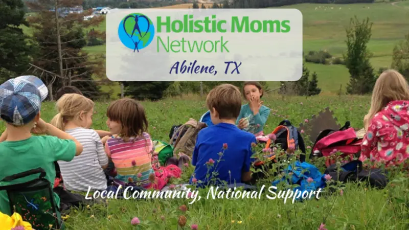children having a snack in a field, holistic moms network logo top center with Abilene TX chapter, bottom center reads Local Community, National Support