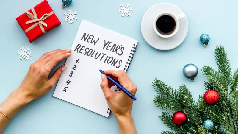 New Year's resolutions with Christmas decorations. Overhead view
