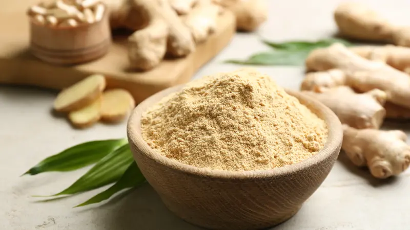 Dry and fresh ginger on light grey table, closeup