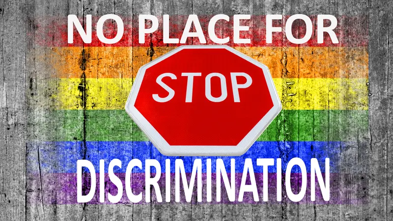 No place for discrimination and STOP sign and LGBT flag painted on background texture gray concrete