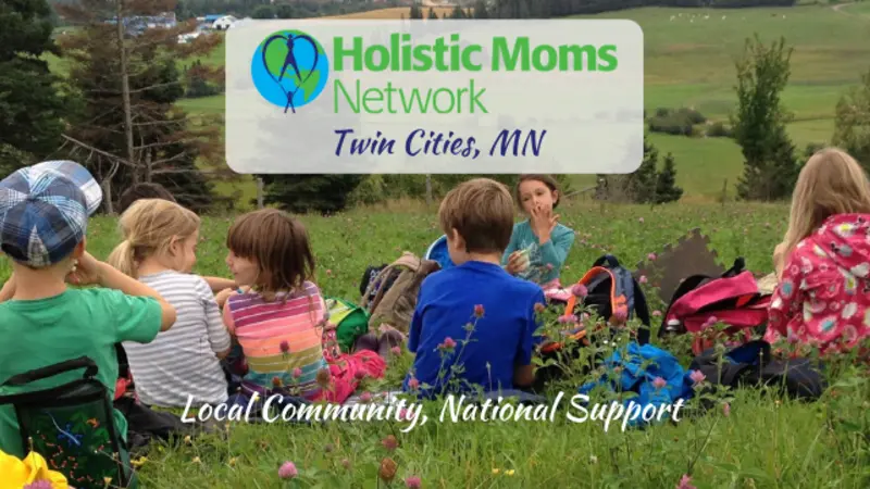 children having a snack in a field, holistic moms network logo top center with Twin Cities MN chapter, bottom center reads Local Community, National Support