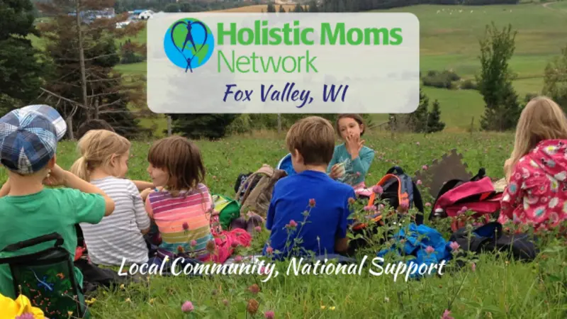 children having a snack in a field, holistic moms network logo top center with Fox Valley, WI chapter, bottom center reads Local Community, National Support