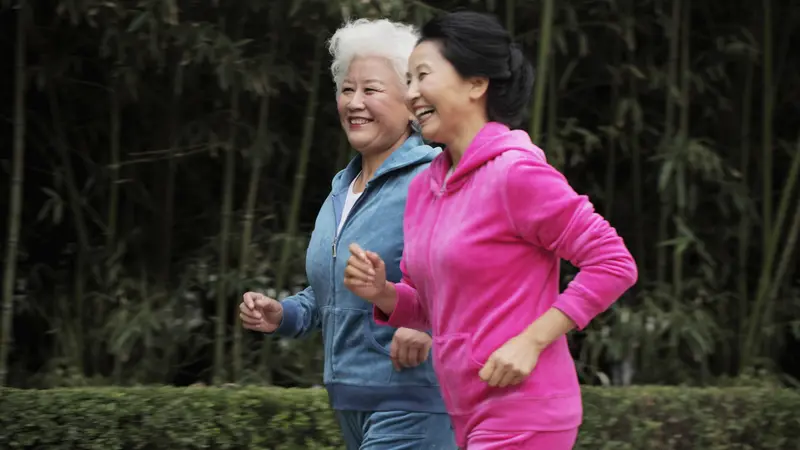 Two older women jogging together