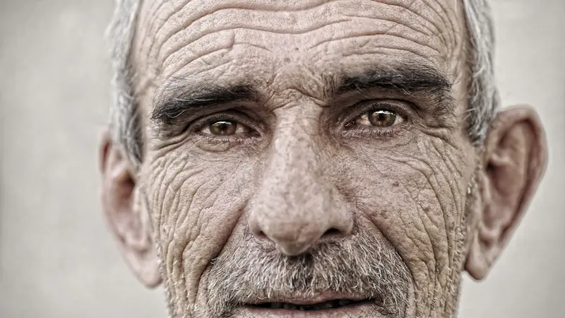 Mature man with wrinkles, close up portrait