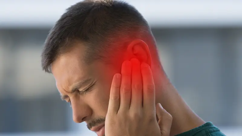 Man suffering from tinnitus Man suffering from tinnitus