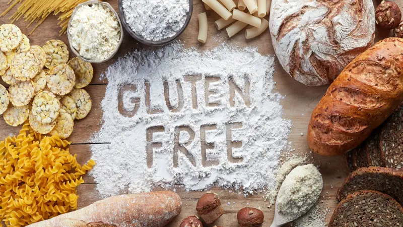 Gluten free food. Various pasta, bread, snacks and flour on wooden background from top view