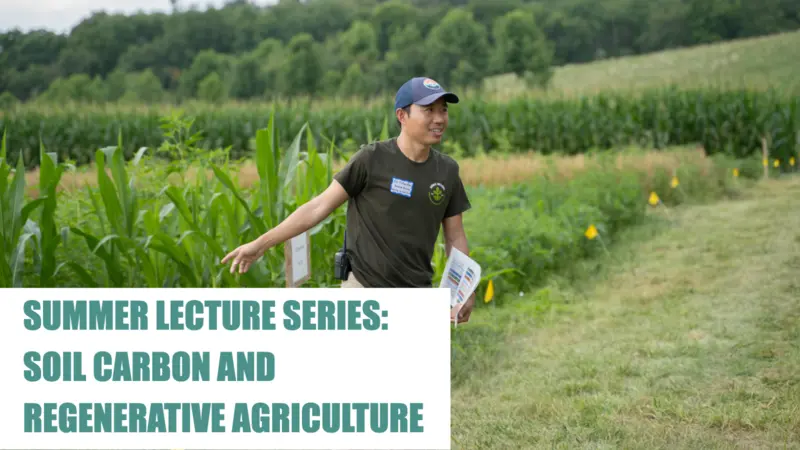 Rodale Institute Worker pointing to a field of crops Rodale Institute Worker pointing to a field of crops