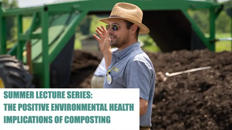 Rodale Institute worker speaking on a farm in front of soil and a tractor