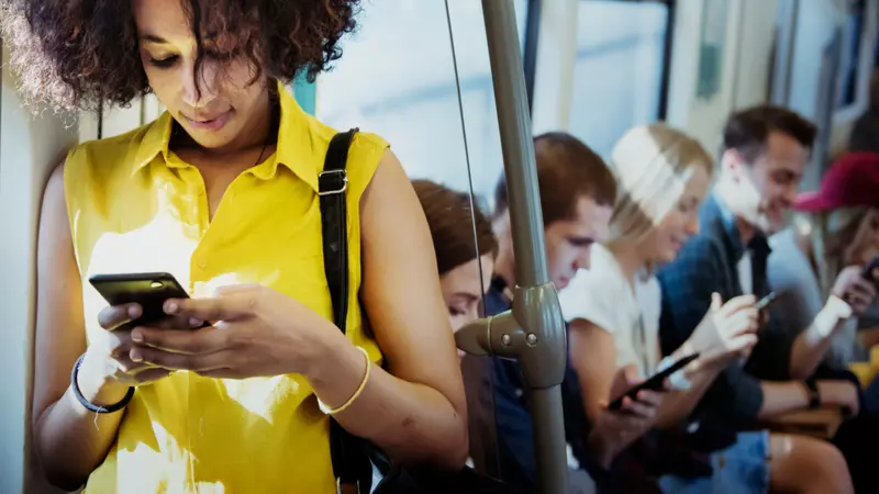 Young woman using a smartphone in a subway