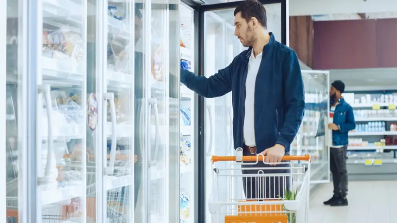 At the Supermarket, Men Browse for Products in the Frozen Goods Section At the Supermarket, Men Browse for Products in the Frozen Goods Section