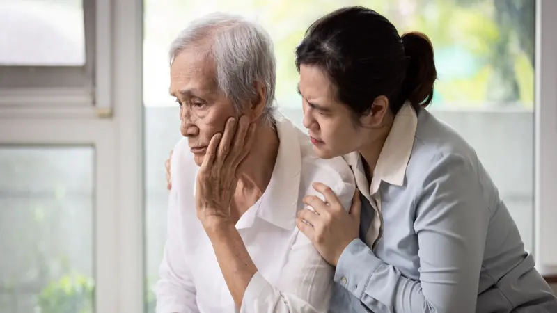 Loving daughter embracing comforting and consoling senior woman