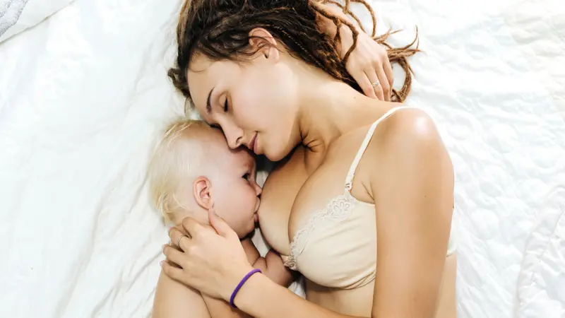 Woman is breastfeeding her child.