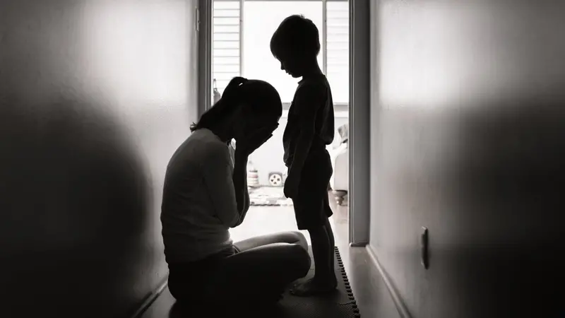 Depressed mother crying next to her child. Depressed mother crying next to her child.