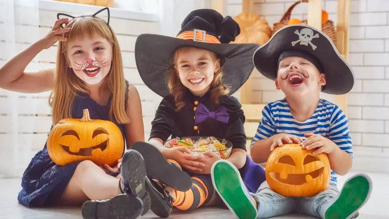 Happy brother and two sisters on Halloween.