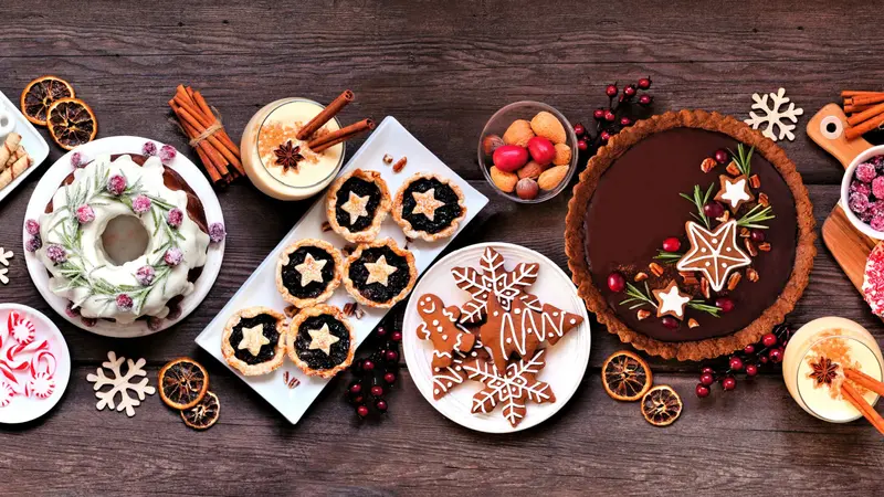 Assorted holiday desserts and sweets. - Bundt cake, chocolate pie, mincemeat tarts, cookies, fudge and eggnog.