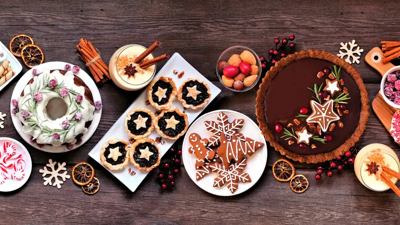 Assorted holiday desserts and sweets. - Bundt cake, chocolate pie, mincemeat tarts, cookies, fudge and eggnog. Assorted holiday desserts and sweets. - Bundt cake, chocolate pie, mincemeat tarts, cookies, fudge and eggnog.