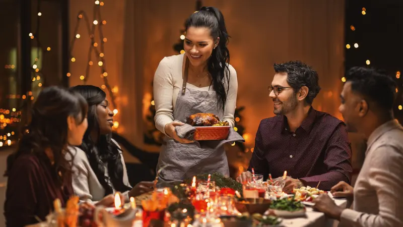  Group of happy friends having Christmas dinner at home