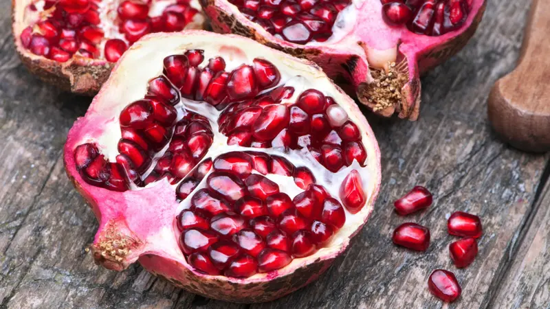 Juicy pomegranates on wood