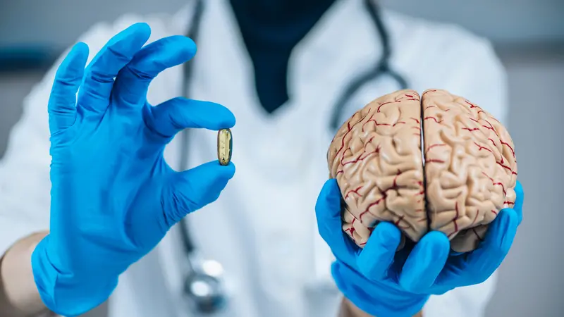 Placebo Effect Concept. Female doctor holding model of brain and placebo supplement pill