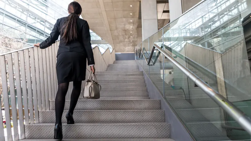 business woman going up the stairs