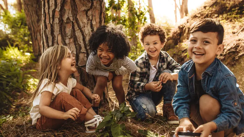 Cute children playing in woods