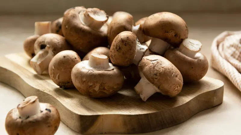Champignons fresh mushrooms on cutting board Champignons fresh mushrooms on cutting board