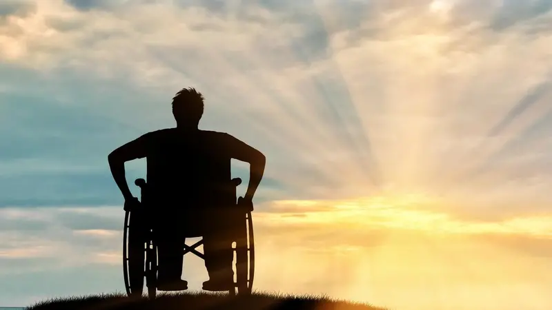 Person in wheelchair enjoying the rays of the sun