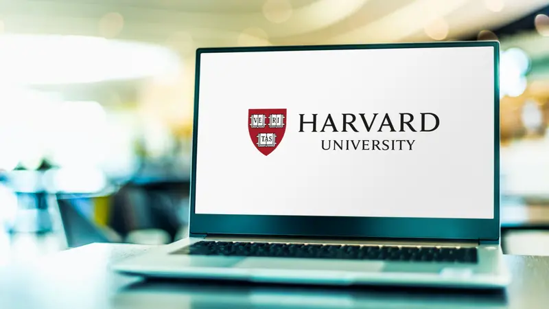 Laptop computer displaying logo of Harvard University