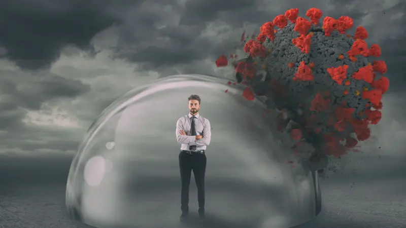 Man safely inside a shield of immunity during coronavirus pandemic. Immunity concept Man safely inside a shield of immunity during coronavirus pandemic. Immunity concept