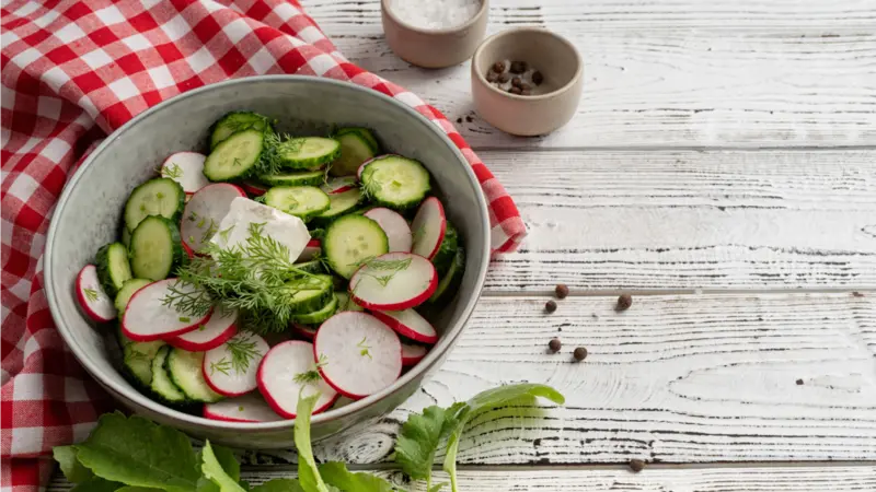 Bowl of healthy vegetarian salad with raddish cucumber and fennel