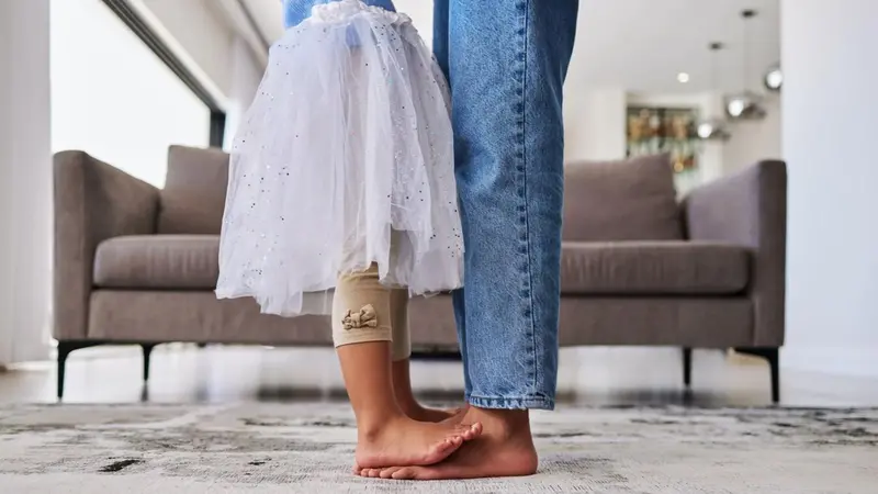Mother dancing with daughter standing on her feet Mother dancing with daughter standing on her feet