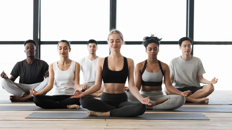 Women and men in a yoga class