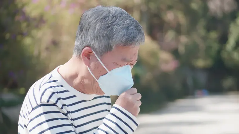 Asian old man coughs and wear protective mask