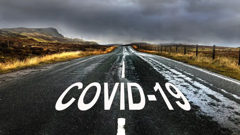 Road with diminishing perspective and text "COVID-19"