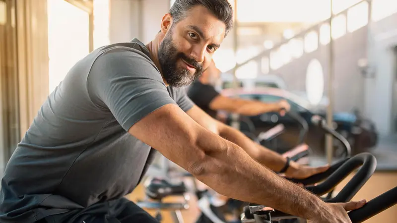 Man riding a stationary bicycle Man riding a stationary bicycle