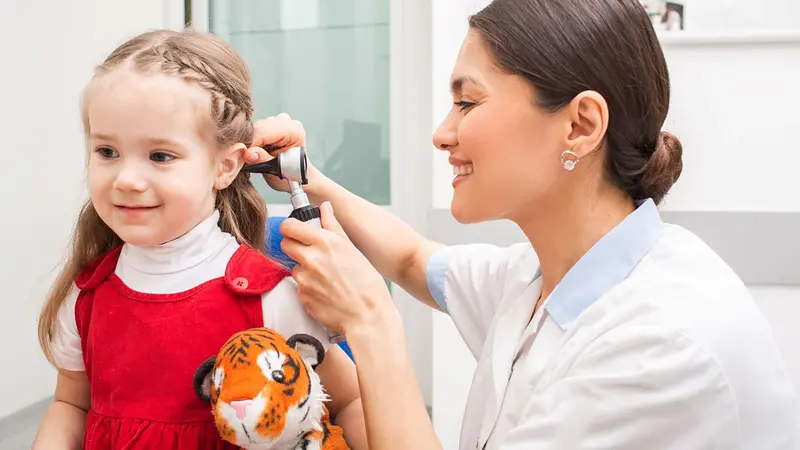 Doctor performing ear exam