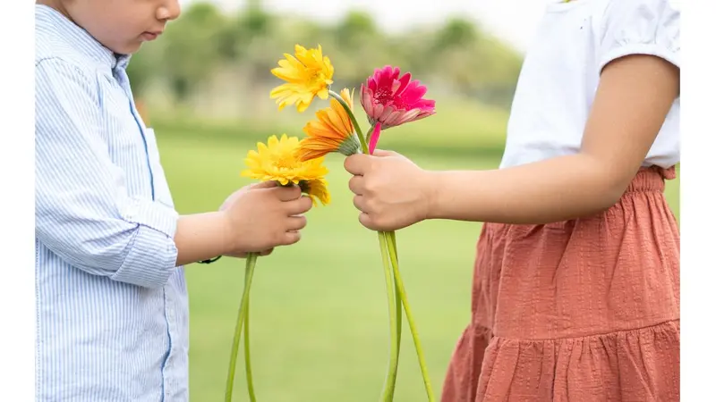 Two kids holding flowers Two kids holding flowers