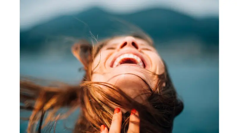 Woman with head back expressing joy Woman with head back expressing joy