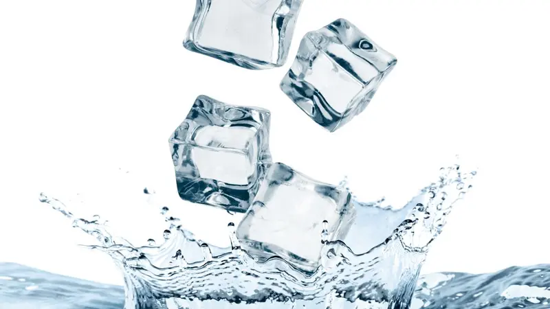 Ice cubes falling into water on white background Ice cubes falling into water on white background